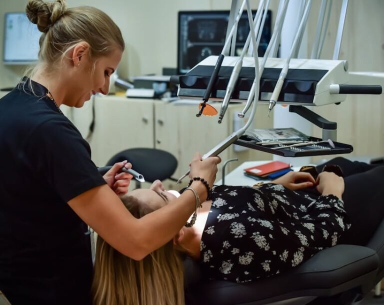 Dental professional conducting examination with advanced equipment in a modern clinic, ensuring patient comfort.