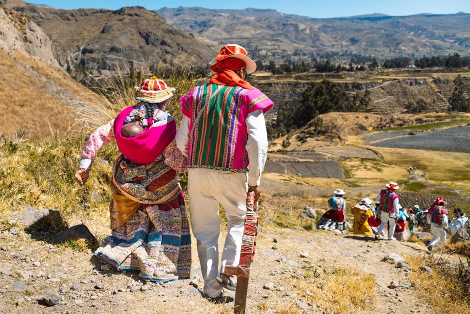 Colorful Andean family walking in rural Arequipa, Peru, showcasing cultural heritage.