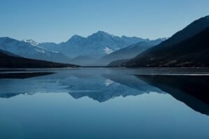 Peaceful mountain landscape with clear reflections in a calm lake.
